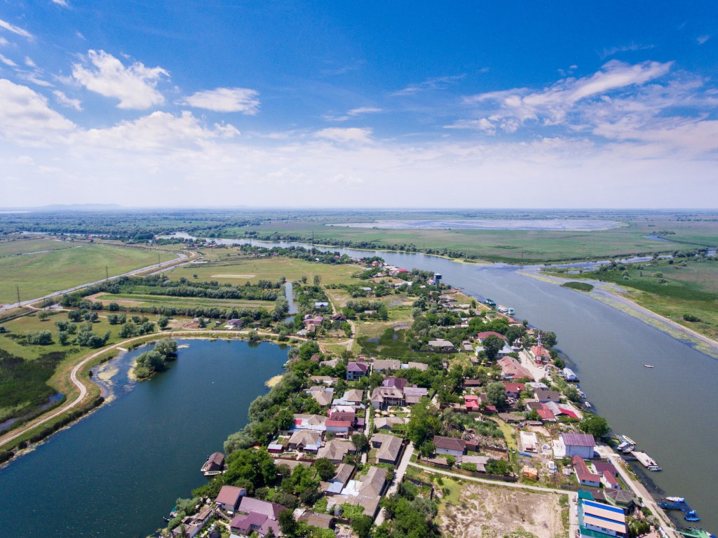 Aerial view of Mila 23 village surrounded by water channels in the Danube Delta, Romania