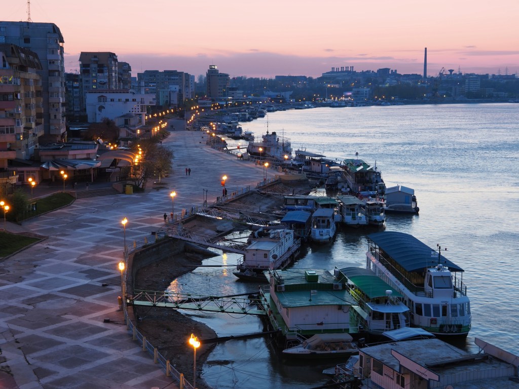 Tulcea port at blue hour, riverfront promenade and boats on the Danube, Romania