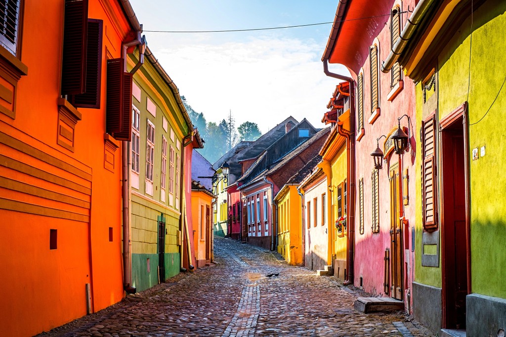 Colourful medieval street in Sighișoara old town, Transylvania, Romania
